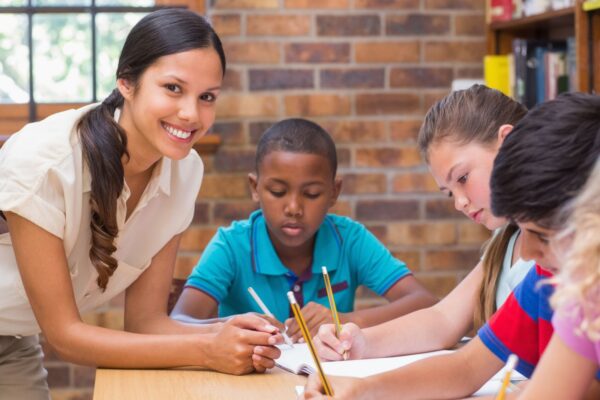 Teacher helping students