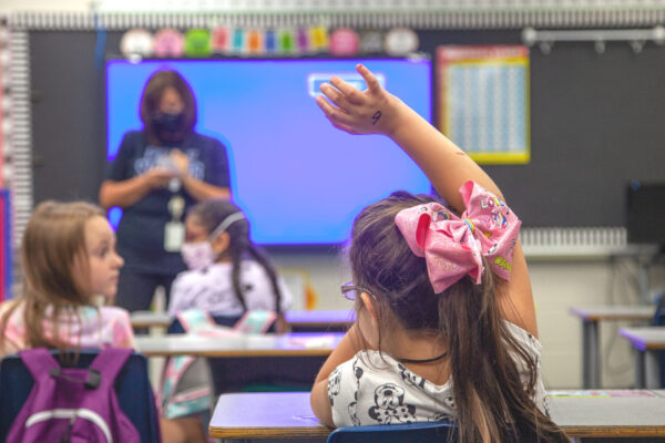 Student raising her hand in class