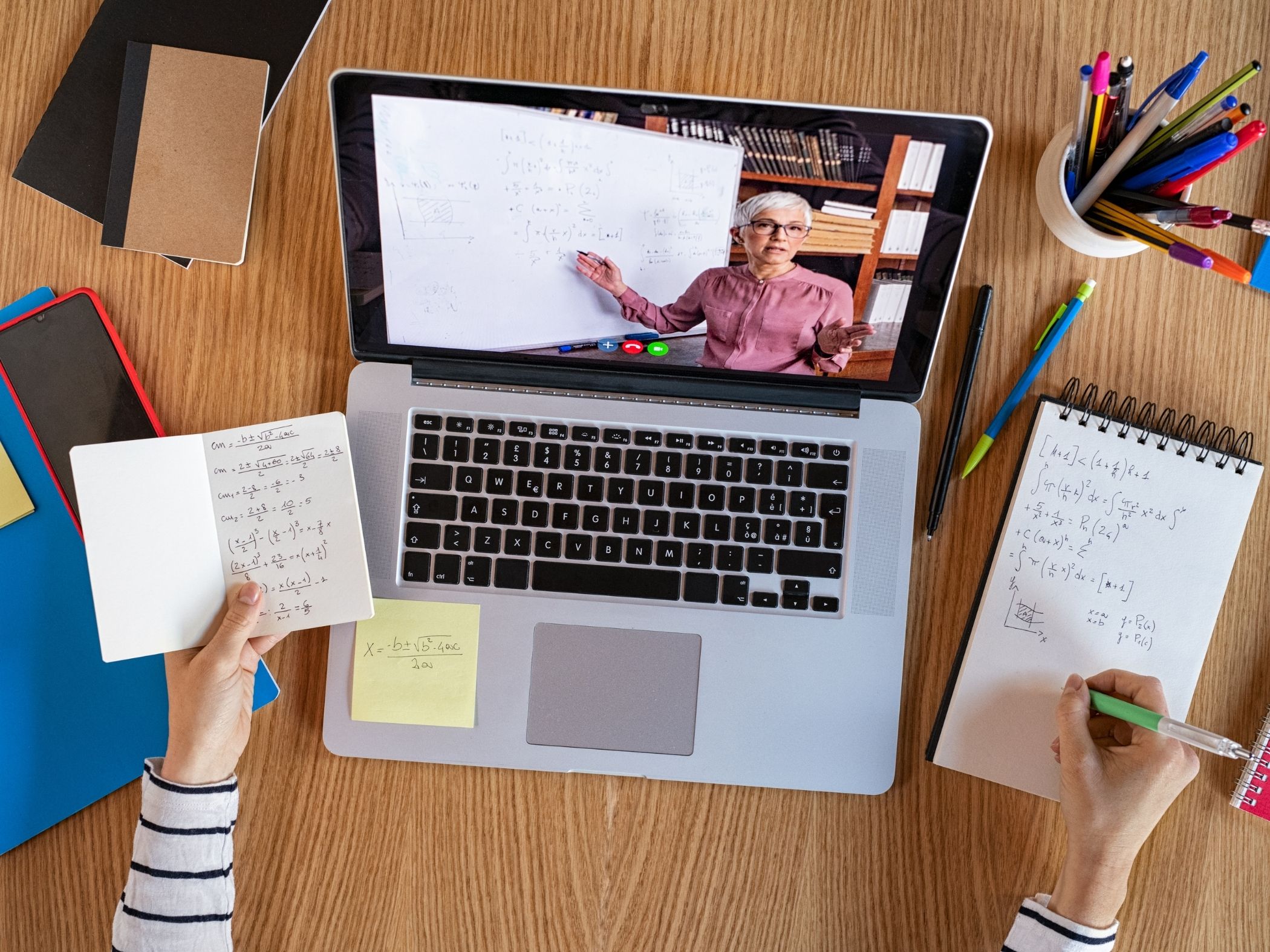 laptop showing elearning lesson with teacher presenting